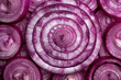 Close up view of a bunch of red onions with a circle in the middle on black background