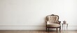 © Lasvu - A timeless chair in a classic style is positioned in front of a plain white wall. The room exudes a vintage ambiance with its minimalist decor.