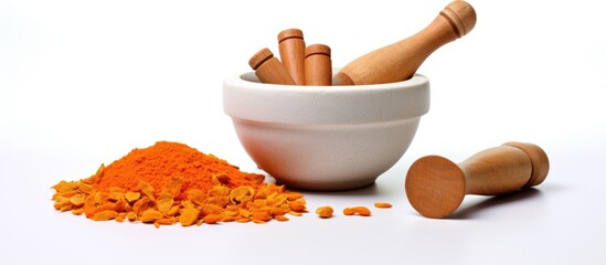 Sticker - A wooden mortar and pestle sit next to a pile of turmeric, a staple ingredient in many cuisines. Turmeric is commonly used as a spice in recipes to add flavor and color to dishes