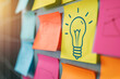 Creative Brainstorming Concept with Lightbulb Drawing on Colorful Sticky Notes