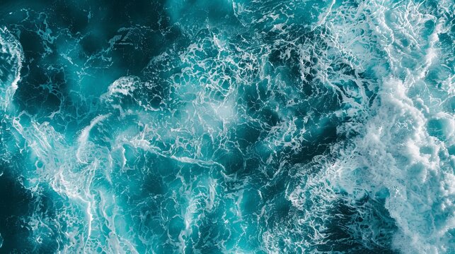 From above aerial view of turquoise ocean water with splashes and foam for abstract natural background and texture