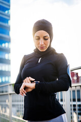 Wall Mural - Arab middle-eastern woman doing sport workout training outdoors in a urban area