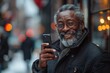 © Dejan - With a cheerful demeanor, a mature businessman records a voice message on his phone, demonstrating the ease and convenience of mobile communication in business settings