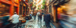 European street, blending architectural charm with the warmth and togetherness of community. People in blurred motion.