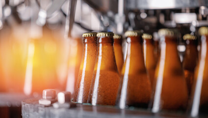 Wall Mural - Beer brewery industry manufacturing. Brown glass bottles on conveyor belt with sunlight