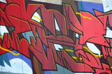 Fototapeta Młodzieżowe - Colorful background of graffiti painting artwork with bright aerosol outlines on wall. Old school street art piece made with aerosol spray paint cans. Contemporary youth culture backdrop