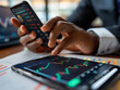 © Business Pics - Businessman using a smartphone app to buy or sell shares of stock market. Investment concept
