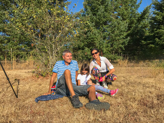 Sticker - A family in the park waiting for a solar eclipse in the countryside