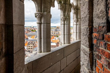 Wall Mural - The narrow stone passageway with arched windows looking out over the city at the top of the medieval Belfort van Gent, Belfry of Ghent, in the city center of Ghent, Belgium.