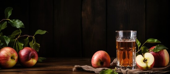 Poster - A glass of apple juice and fresh apples displayed on a rustic wooden tableware. Perfect for a healthy event or as an ingredient in a refreshing recipe