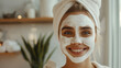 © Daria Lukoiko - A young charming girl with a wide, sincere smile makes a face mask that helps maintain the elasticity, beauty and moisture of the skin. Home spa treatment for women