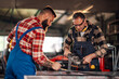 © Zamrznuti tonovi - Colleagues working together as they are preparing for grinding metal.