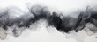 Black smoke is seen floating in the air against a clean white backdrop. The smoky wisps blend into the white space, creating a striking contrast.