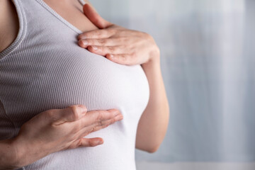 Woman checking her breast, breast self-exam (BSE), Breast Cancer Awareness