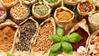 Assorted spices and herbs in paper bags on a table colorful seasoning ingredients spread out for cooking