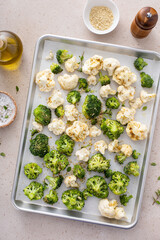 Wall Mural - Broccoli and cauliflower florets on a sheet pan ready to be roasted