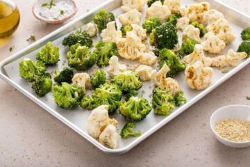 Wall Mural - Broccoli and cauliflower florets on a sheet pan ready to be roasted