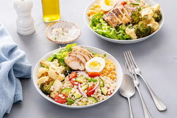 Wall Mural - Healthy lunch bowl with grilled chicken, roasted vegetables, fresh lettuce, cooked lentils, salad and boiled egg