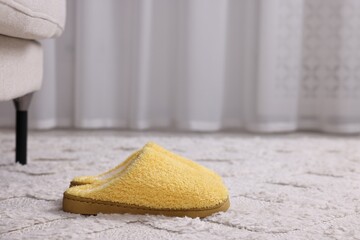 Wall Mural - Yellow soft slippers on light carpet. Space for text