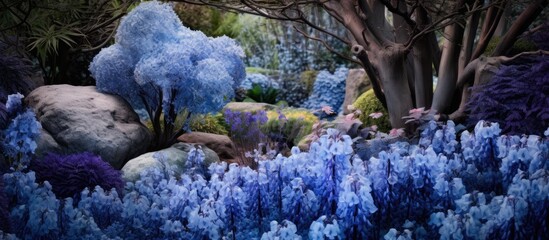 Sticker - A natural landscape transformed into an electric blue haven with plants, flowers, and trees. The garden is an artful display of vibrant blue hues