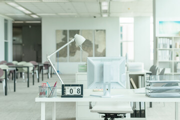 Interior of a modern office with computer and white furniture