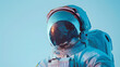 Close up of astronaut in electric blue helmet against blue sky