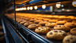 Automatic bakery production line with sweet cookies on conveyor belt equipment machinery in confectionary factory workshop.