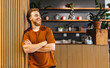 © Jacob Lund - Happy business man standing in front of a cafe in a coworking ofice
