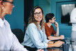 © Jacob Lund - Portrait of a professional woman sitting in a business meeting with her colleagues