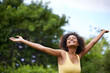 © Mapodile/peopleimages.com - Happy, open arms and black woman in park for freedom, adventure and relax in nature. Smile, excited and person with happiness, positive attitude and fun outdoors for holiday, vacation and weekend