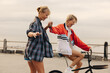 © Jacob Lund - Carefree bike ride with best friends through seaside promenade