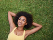 © Mapodile/peopleimages.com - Happy, grass and above of black woman in park for thinking, wondering and relax in nature. Smile, garden and top view of person laying outdoors for holiday, vacation and weekend for calm or peace