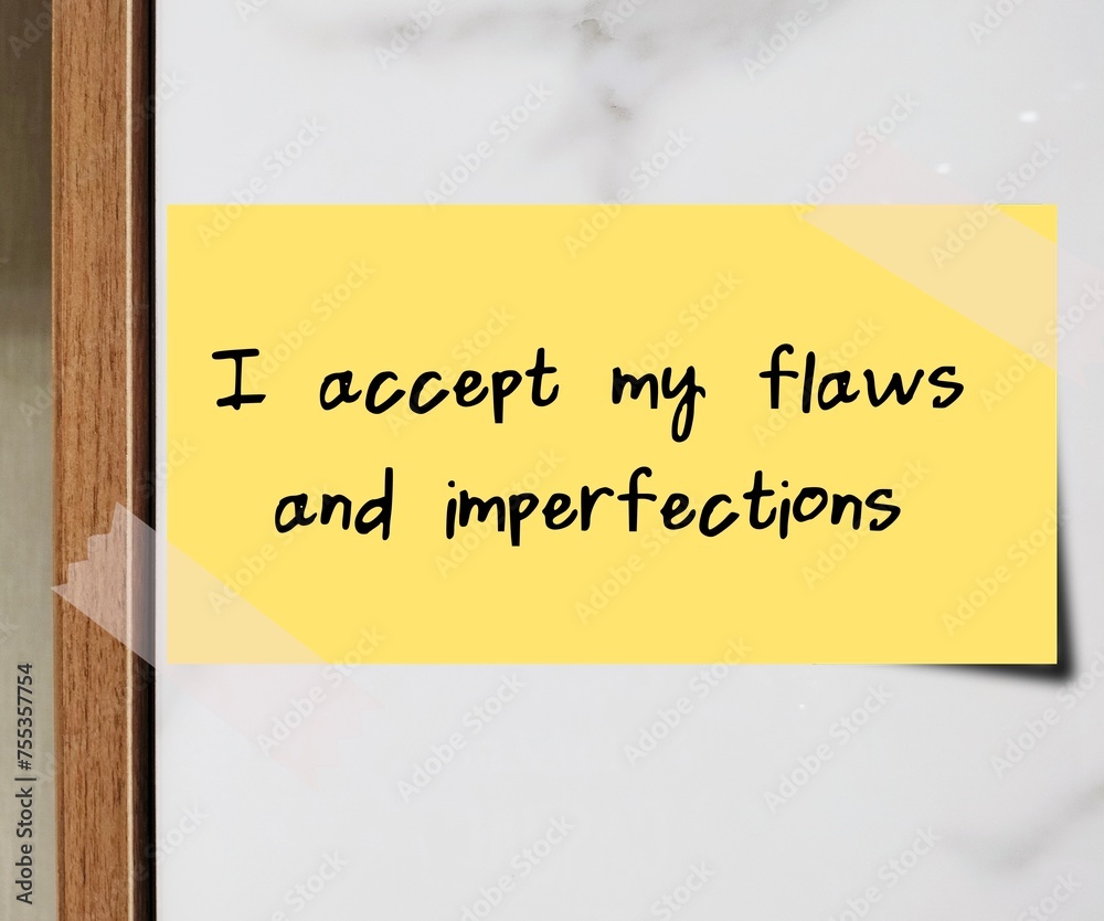 Stick note on wall with handwritten message I ACCEPT MY FLAWS AND ...