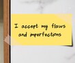 Stick note on wall with handwritten message I ACCEPT MY FLAWS AND IMPERFECTS , positive self talk of self love , self compassion, self acceptance and self validation by embracing imperfection