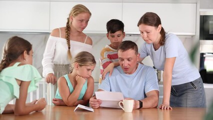 Wall Mural - Loving wife with children comfort upset man at home table