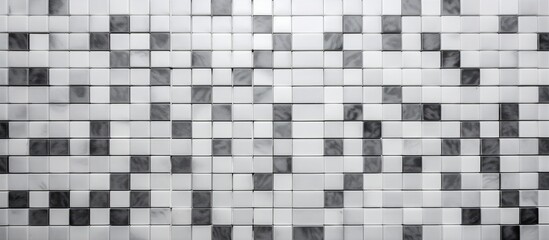 Poster - A monochromatic tiled wall featuring a pattern of white mosaic tiles on a grey square texture background, exuding a sense of luxury and elegance.