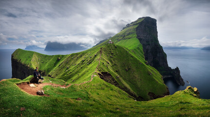 Canvas Print - Kallur lighthouse on green hills of Kalsoy island on sunset time, Faroe islands, Denmark. Landscape photography