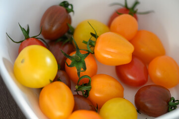 Wall Mural - Various colorful cherry tomatoes in a plate