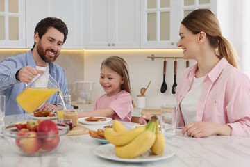 Poster - Happy family having breakfast at table in kitchen