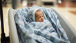 Newborn in a bassinet after birth wrapped in a blanket