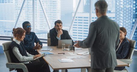 Poster - Back View of Caucasian Male Entrepreneur Talking On Board Of Directors Meeting In Corporate Office. Diverse Investors Listening And Discussing With Businessman Growth Strategy For Consulting Company.