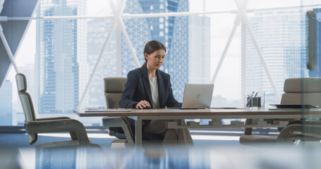 Poster - Professional Female CEO Typing On Laptop Computer In Bright Megapolis View Corner Office. Caucasian Woman Working Alone In Meeting Room Of Investment Management Firm, Looking For Startups to Invest.