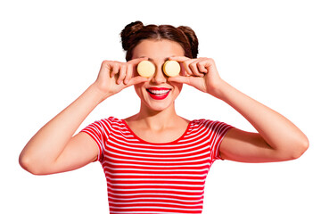 Wall Mural - Close-up portrait of nice cute charming attractive glamorous funny cheerful cheery girl in striped t-shirt covering closing eyes with colorful delicious snack isolated over pink background