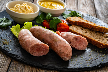 Wall Mural - Easter breakfast - boiled white sausages, toasts and horseradish on wooden table

