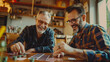 © Keitma - Two happy mature men playing to a card game on a table at home