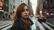 young attractive woman with a natural look walks across the street in a big city looking at the camera