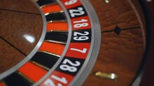 Red color casino roulette, poker game. roulette wheel. Casino theme, betting, online casino, bets, winnings. wooden casino roulette wheel with ball. Luxury casino roulette. close-up video