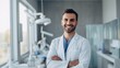 Portrait Of A Smiling Man, Dentist, Orthodontist With Crossed Arms In A Modern Dental Clinic. Teeth cleaning, Caries treatment, Whitening, Veneers, Healthcare, Oral hygiene, teeth check-up concepts.