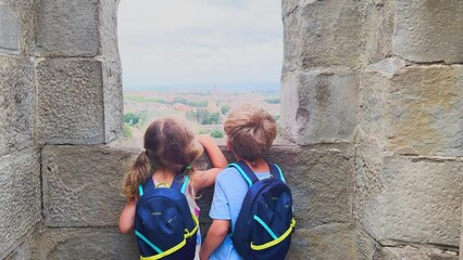 Wall Mural - Young adventurers gaze out from Carcassonne castle walls