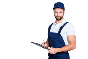 Wall Mural - Portrait with copyspace, empty place of virile harsh deliver in blue uniform having clipboard, pen in hands looking at camera isolated on grey background